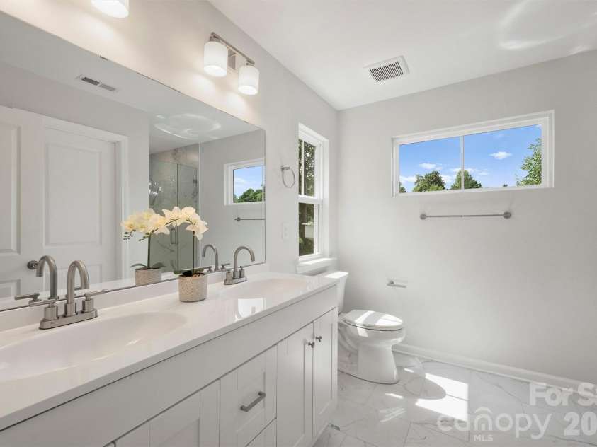126 Meadow Glen Drive, Troutman, NC 28166.  MLS# CAR4340501, YatesRealty ID 3819. Primary ensuite bathroom with double vanity and tile floors.