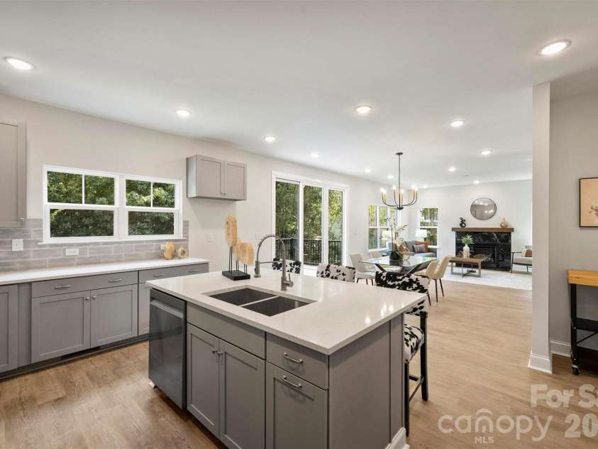 126 Meadow Glen Drive, Troutman, NC 28166.  MLS# CAR4340501, YatesRealty ID 3819. Well designed kitchen featuring an island with sink, tile backsplash, generous counter space and ample cabinetry.