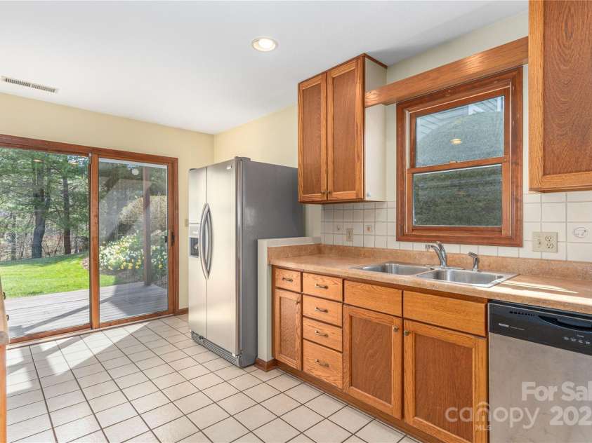 30 Cedarcliff Circle, Asheville, NC 28803.  MLS# CAR4235579, YatesRealty ID 3820. Light-filled kitchen opening to additional back deck.