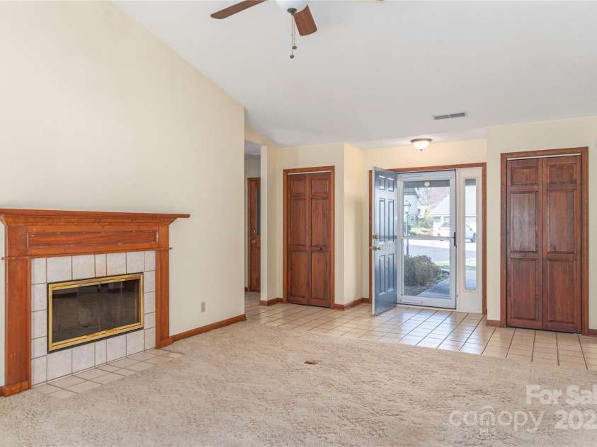 30 Cedarcliff Circle, Asheville, NC 28803.  MLS# CAR4235579, YatesRealty ID 3820. Light-filled living room with wood-burning fireplace.