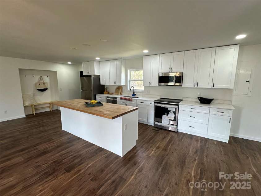 6096 Hwy 151 Highway, Jefferson, SC 29718.  MLS# CAR4241807, YatesRealty ID 3823. Open kitchen to the spacious living/breakfast and dining space, looking towards back door