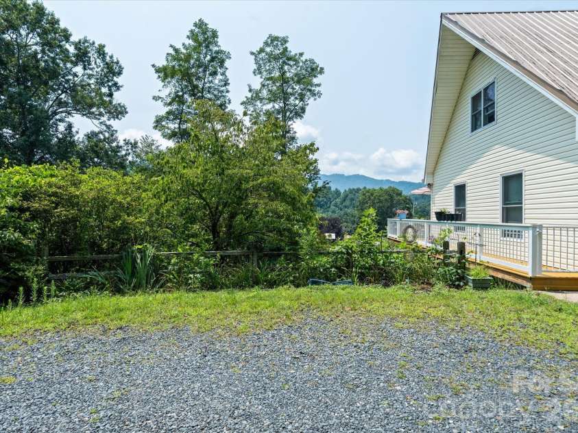 530 West Side Road, Burnsville, NC 28714.  MLS# CAR4403042, YatesRealty ID 38233. Side deck leads to covered back deck.