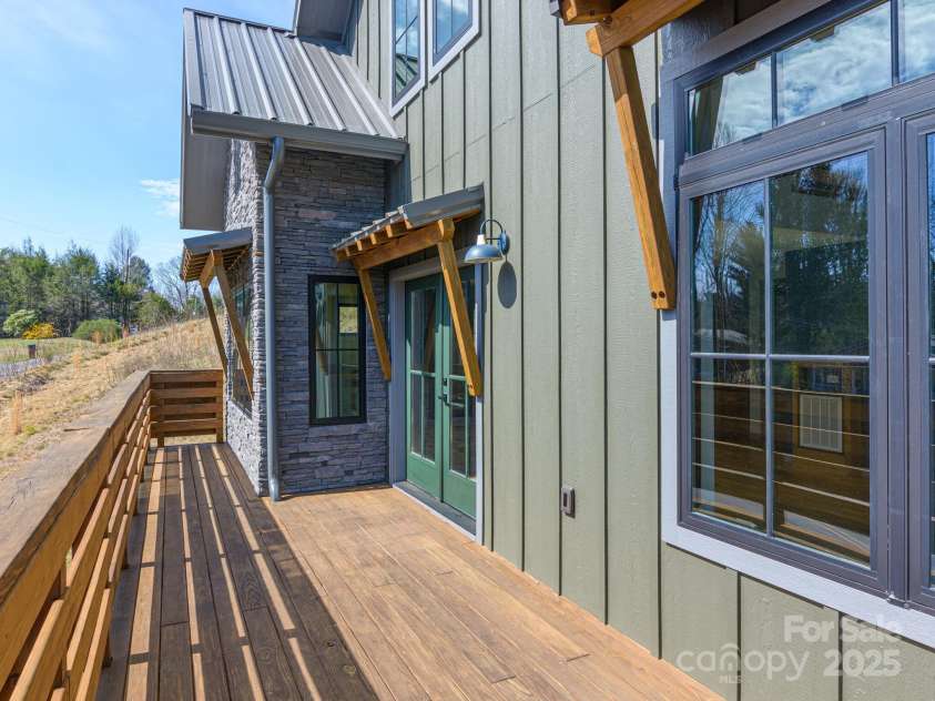 147 Abundance Run, Asheville, NC 28805.  MLS# CAR4240890, YatesRealty ID 3824. Large deck with french doors leading into the main level of home.