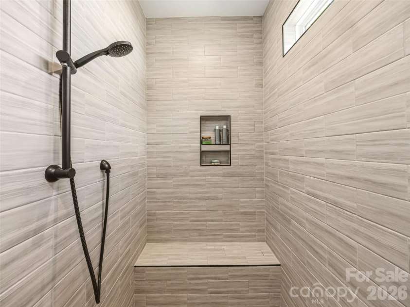 181 Byron Forest Drive, Horse Shoe, NC 28742.  MLS# CAR4400079, YatesRealty ID 38308. Tile shower w/ bench