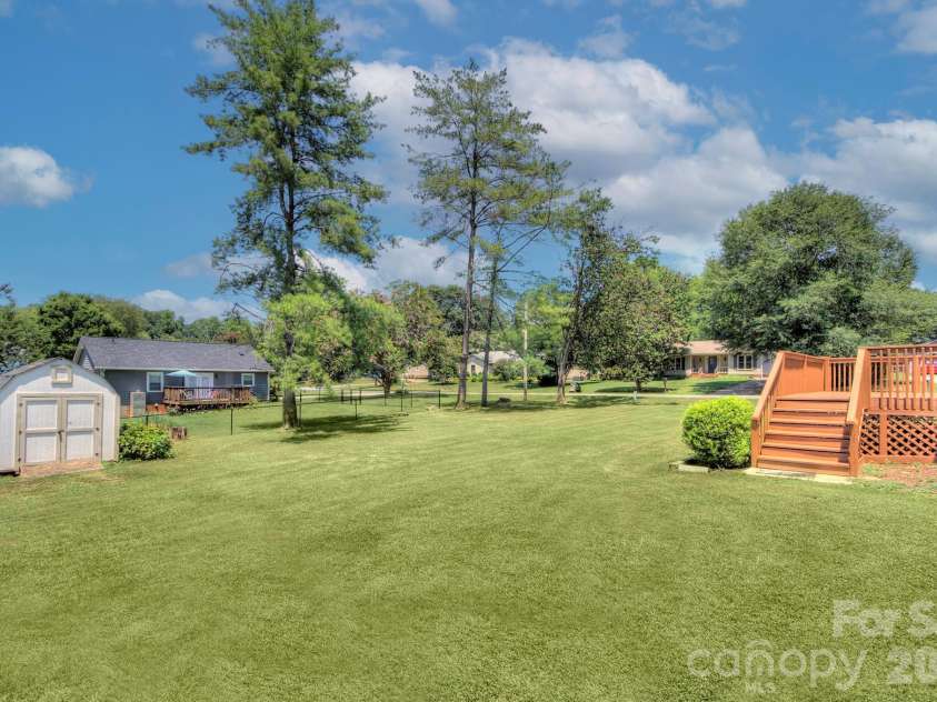 2603 Cherokee Court, Gastonia, NC 28056.  MLS# CAR4402917, YatesRealty ID 38309. Enjoy an expansive, level backyard complete with a spacious deck, storage building and endless room to relax, entertain and play