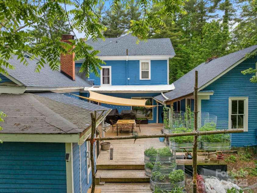 305 Ficker Circle, Hendersonville, NC 28739.  MLS# CAR4240043, YatesRealty ID 3831. Rear of house with unfinished cottage to the right