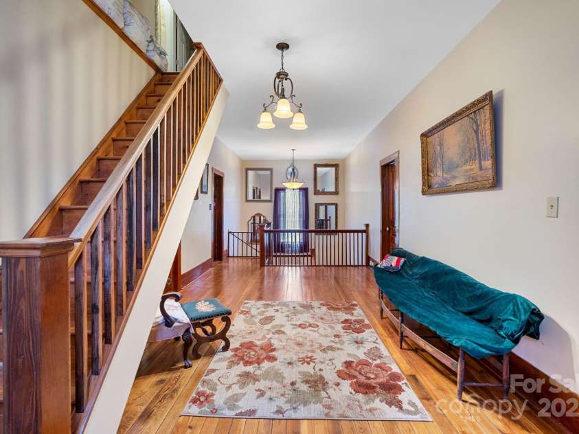 305 Ficker Circle, Hendersonville, NC 28739.  MLS# CAR4240043, YatesRealty ID 3831. Second-floor foyer. Stairs at left lead to third-floor attic (attic offers another full bath and plenty of space to build out).