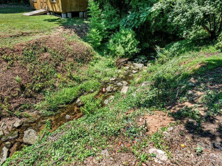 407 10th Street Drive, Hickory, NC 28601.  MLS# CAR4405219, YatesRealty ID 38350. Creek at rear yard.