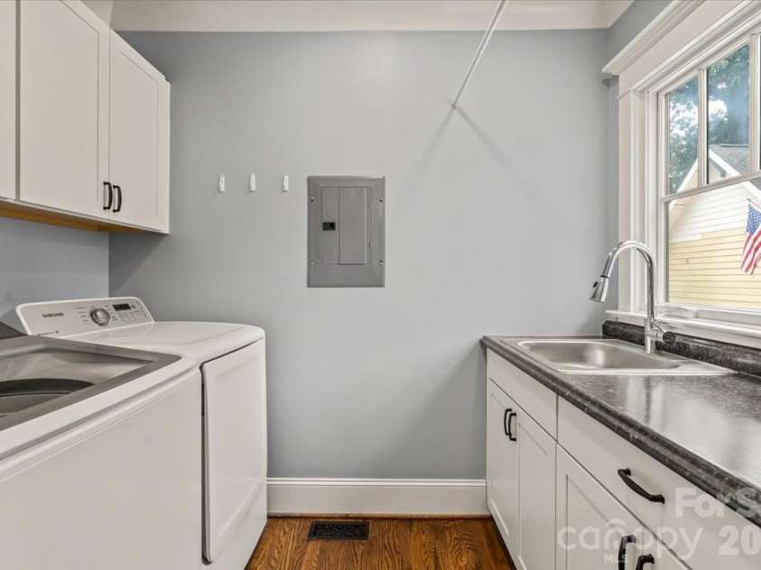 1931 Chatham Avenue, Charlotte, NC 28205.  MLS# CAR4396388, YatesRealty ID 38365. Practicality has its place, too. With generous storage, countertop workspace, and a utility sink, this laundry room is ready to keep up with daily life.
