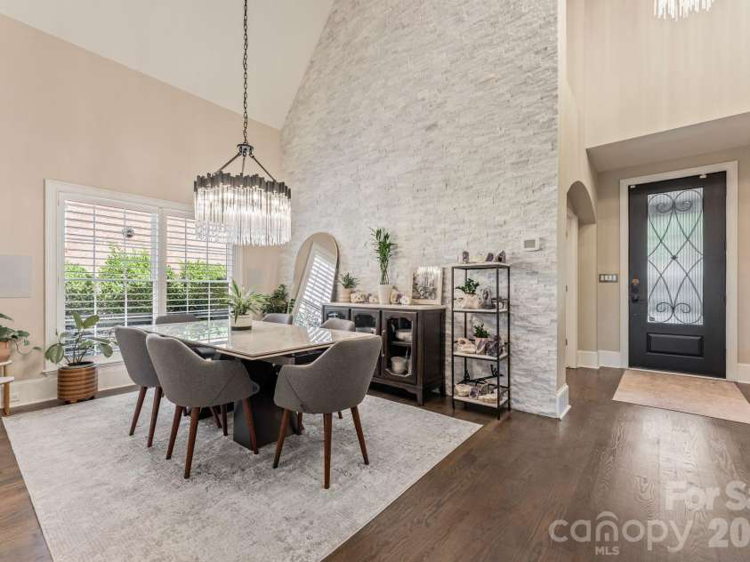 17411 Summer Place Drive, Cornelius, NC 28031.  MLS# CAR4401453, YatesRealty ID 38428. Dining area with designer chandelier and painted-brick accent wall, conveniently positioned off the main entry.