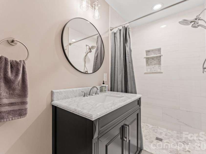 17411 Summer Place Drive, Cornelius, NC 28031.  MLS# CAR4401453, YatesRealty ID 38428. Full bath with step-in shower and modern single vanity.