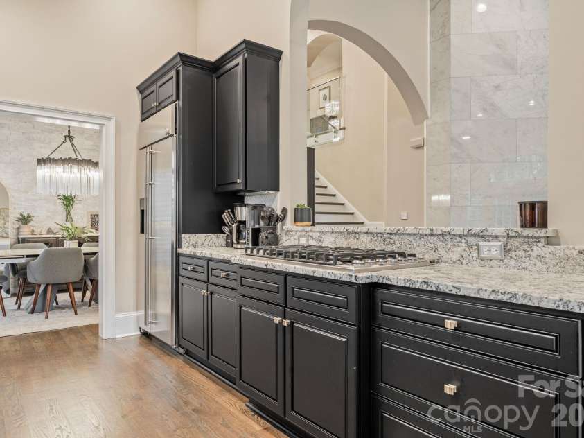 17411 Summer Place Drive, Cornelius, NC 28031.  MLS# CAR4401453, YatesRealty ID 38428. Oversized kitchen island with stone-look counters and arched architectural detail - the heart of the home.
