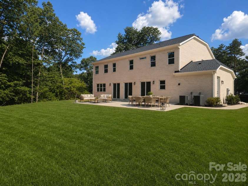332 Point Carpenter Road, Indian Land, SC 29707.  MLS# CAR4393958, YatesRealty ID 38464. Step out back onto the oversized rear patio, perfect for weekend entertaining. The patio overlooks your vast, ultra-private 2.14-acre backyard, offering plenty of room for a future custom pool or private garden.