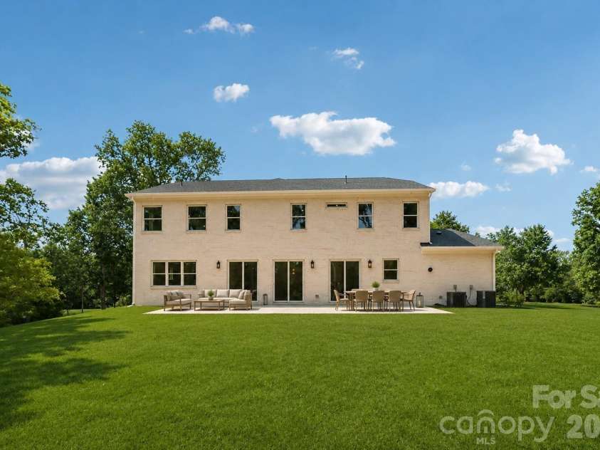 332 Point Carpenter Road, Indian Land, SC 29707.  MLS# CAR4393958, YatesRealty ID 38464. This expansive backyard features an oversized patio, making it the perfect space for outdoor entertaining while offering ample privacy and plenty of room to install a pool.