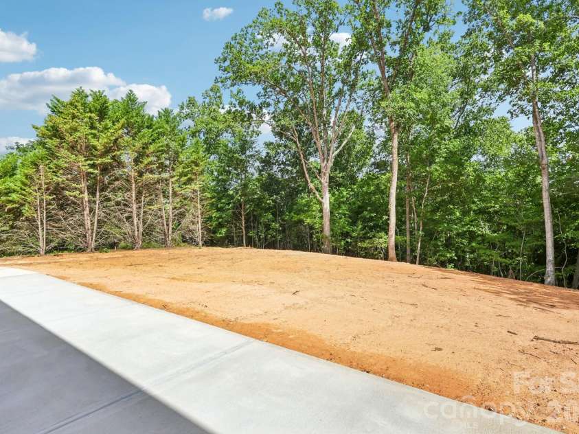 332 Point Carpenter Road, Indian Land, SC 29707.  MLS# CAR4393958, YatesRealty ID 38464. This expansive backyard features an oversized patio, making it the perfect space for outdoor entertaining while offering ample privacy and plenty of room to install a pool.