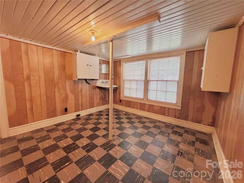 5057 Erickson Road, Charlotte, NC 28208.  MLS# CAR4389142, YatesRealty ID 38485. Additional basement space that was once  used for a kitchen and dining area. There is also plumbing in the adjacent room for a restroom.