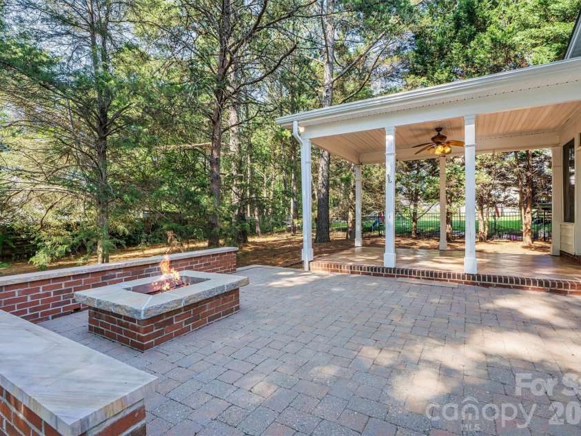 7542 Sedgebrook Drive, Stanley, NC 28164.  MLS# CAR4401228, YatesRealty ID 38497. Patio w/ built in fire pit