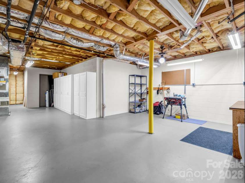 115 Woodhaven Drive, Hendersonville, NC 28739.  MLS# CAR4389153, YatesRealty ID 38498. Basement storage with Workshop