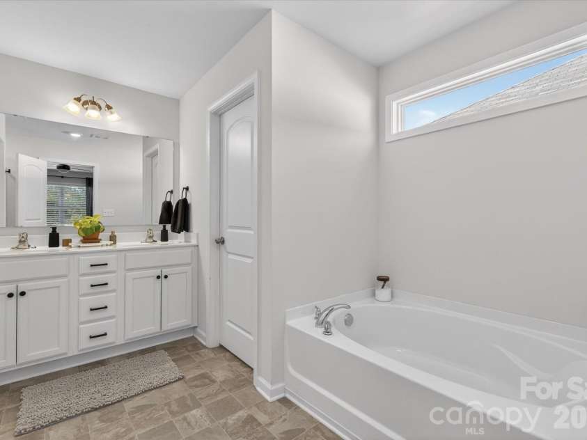 6002 Weddington Pointe Drive, Monroe, NC 28110.  MLS# CAR4377599, YatesRealty ID 38507. Owner's dual vanities and soaking tub