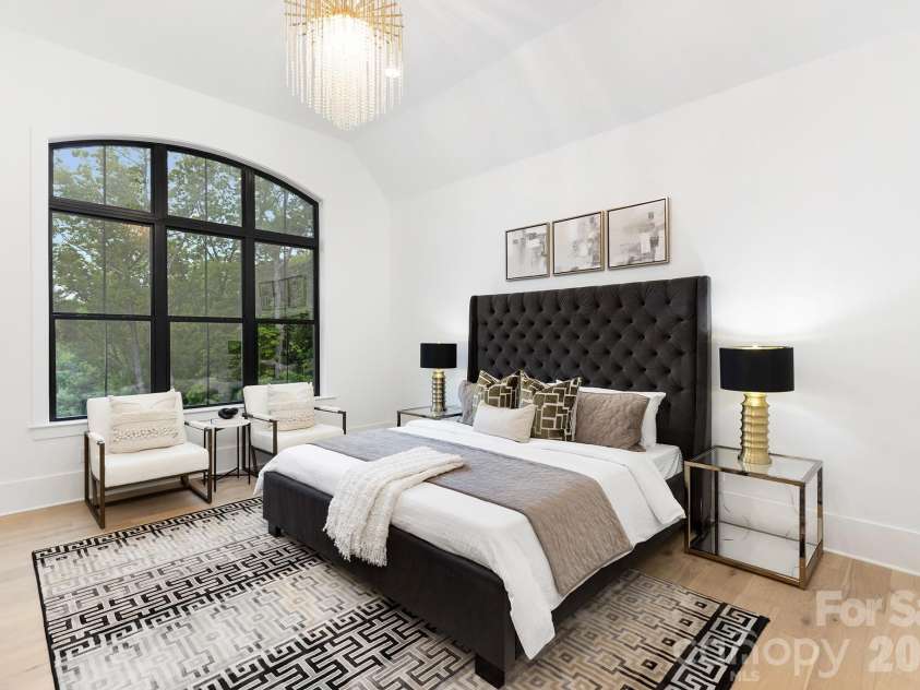 18304 Rosapenny Road, Charlotte, NC 28278.  MLS# CAR4329867, YatesRealty ID 3855. Primary bedroom with spectacular water view, atrium windows, elegant chandelier and cathedral ceiling