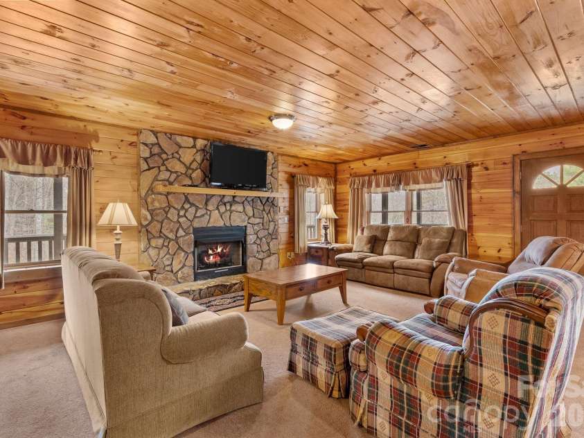 264 Moonbeam Lane, Clyde, NC 28721.  MLS# CAR4344576, YatesRealty ID 3856. Downstairs Living room 