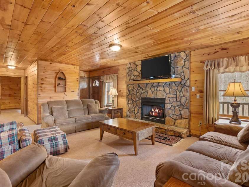 264 Moonbeam Lane, Clyde, NC 28721.  MLS# CAR4344576, YatesRealty ID 3856. Downstairs living room 