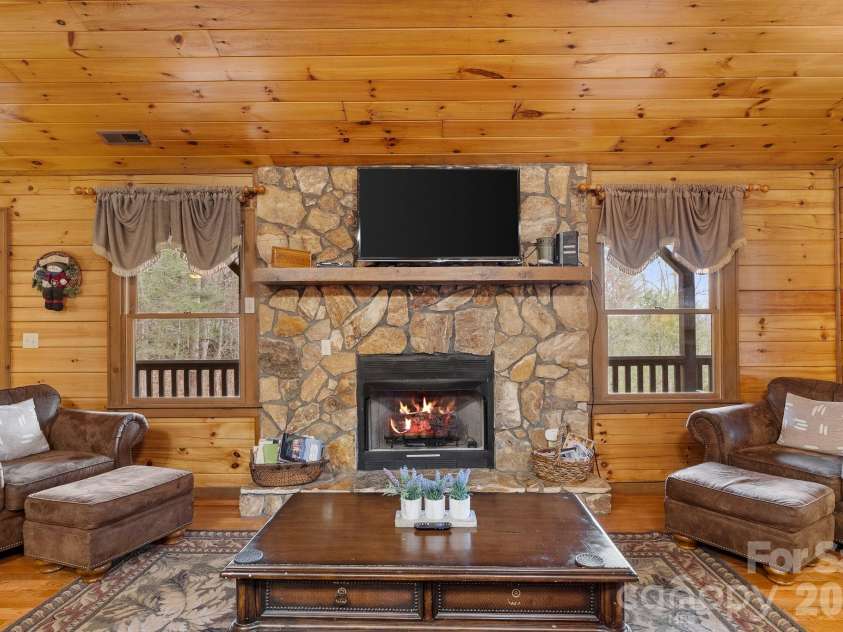 264 Moonbeam Lane, Clyde, NC 28721.  MLS# CAR4344576, YatesRealty ID 3856. Living room up with fireplace 