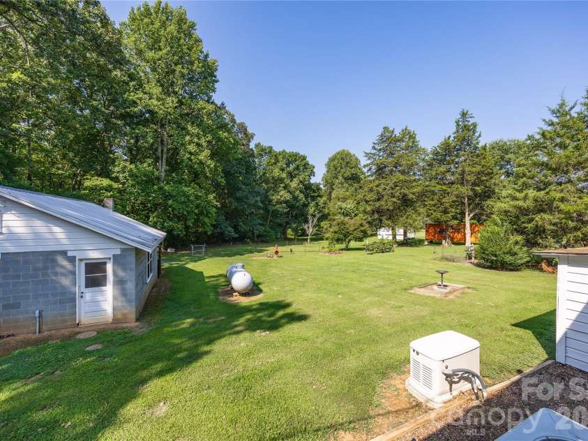545 Mt. Shepherd Road, Asheboro, NC 27205.  MLS# CAR4403323, YatesRealty ID 38584. Back yard with Generac generator