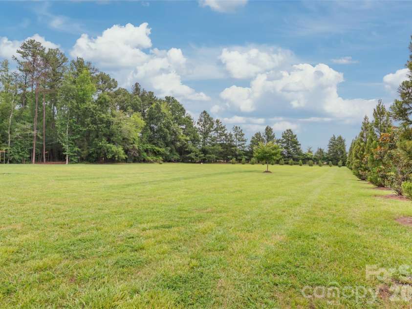 1808 Huntley Ridge Drive, Concord, NC 28025.  MLS# CAR4401612, YatesRealty ID 38588. Sprawling Level Backyard