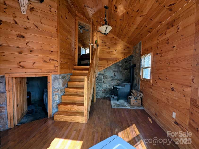 10120 Meadow Fork Road, Hot Springs, NC 28743.  MLS# CAR4218136, YatesRealty ID 3864. Lower level with wood stove, washer/dryer and cellar