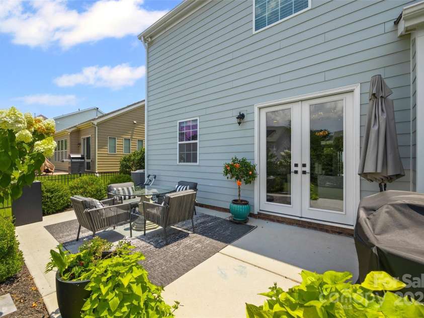 17622 Austins Creek Drive, Charlotte, NC 28278.  MLS# CAR4278255, YatesRealty ID 3867. Charming backyard retreat with patio featuring gorgeous plants and lush green grass-polished and appealing.