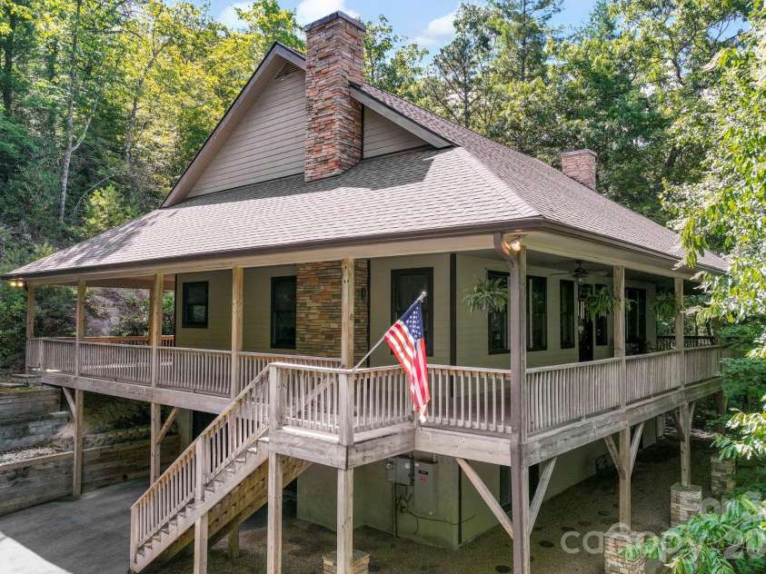 149 Oriole Road, Brevard, NC 28712.  MLS# CAR4404577, YatesRealty ID 38675. Elevated perspective showcasing the home's wraparound porch and private mountain setting.