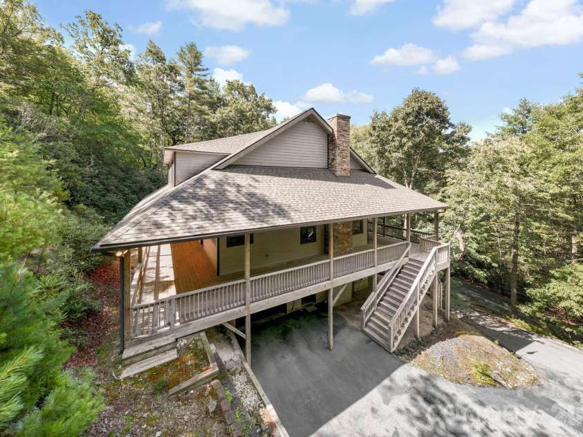 149 Oriole Road, Brevard, NC 28712.  MLS# CAR4404577, YatesRealty ID 38675. Elevated view highlighting the home's secluded location surrounded by mature trees.