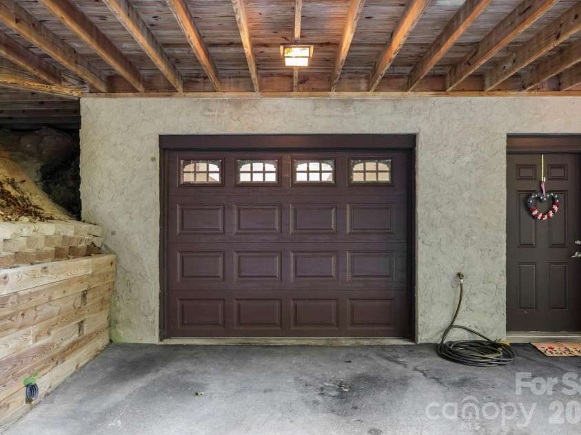 149 Oriole Road, Brevard, NC 28712.  MLS# CAR4404577, YatesRealty ID 38675. Oversized lower-level garage with covered entry and additional storage space.