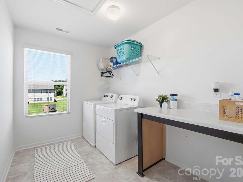 1295 Elizabeth Avenue, Kannapolis, NC 28083.  MLS# CAR4388265, YatesRealty ID 38707. Oversized laundry room with folding table