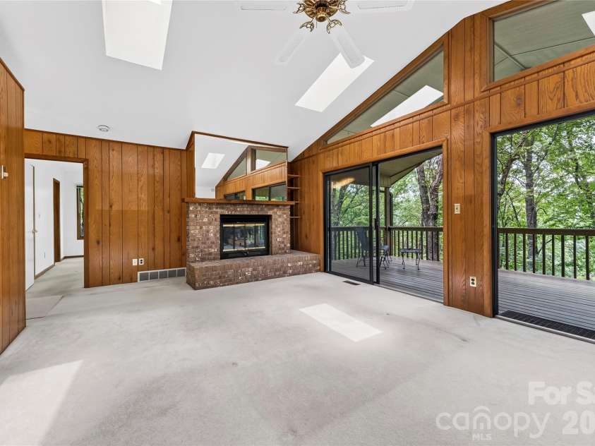 109 Usdasdi Drive, Brevard, NC 28712.  MLS# CAR4405898, YatesRealty ID 38717. Large windows frame the wooded setting