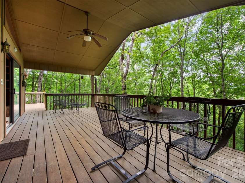 109 Usdasdi Drive, Brevard, NC 28712.  MLS# CAR4405898, YatesRealty ID 38717. Spacious rear deck overlooking the wooded landscape