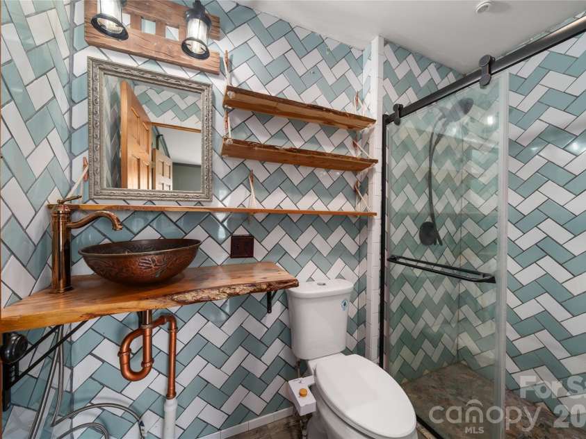 1271 Upper Brush Creek Road, Fairview, NC 28730.  MLS# CAR4398418, YatesRealty ID 38771. Second full bath in Primary Suite
