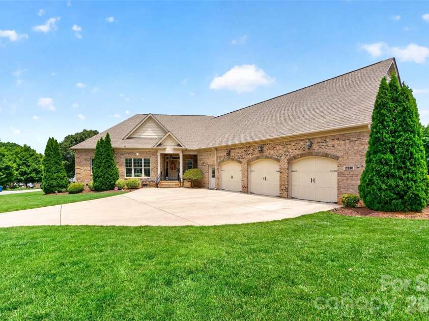 2330 Shiny Leaf Drive, Denver, NC 28037.  MLS# CAR4384279, YatesRealty ID 38812. Front of home.  Three car garage.