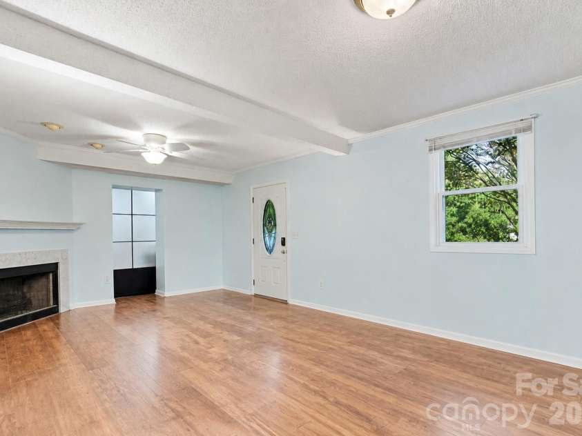 7132 Clear Crossing Lane, Mint Hill, NC 28227.  MLS# CAR4404373, YatesRealty ID 38815. Lower Level entry Living Room (Virtually Emptied)