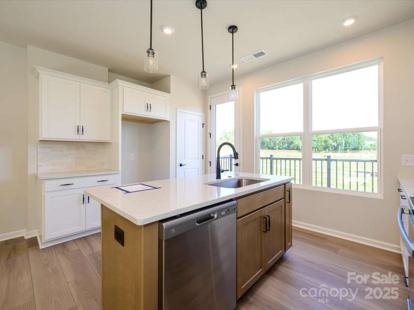 5711 Castlerea Drive, Charlotte, NC 28217.  MLS# CAR4232177, YatesRealty ID 3882. Cabinet color change at the island provides design interest to the space.