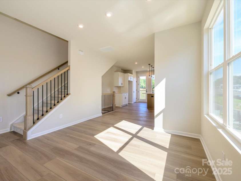 5711 Castlerea Drive, Charlotte, NC 28217.  MLS# CAR4232177, YatesRealty ID 3882. Dining space connecting the kitchen to the great room and open rail to keep the space open.