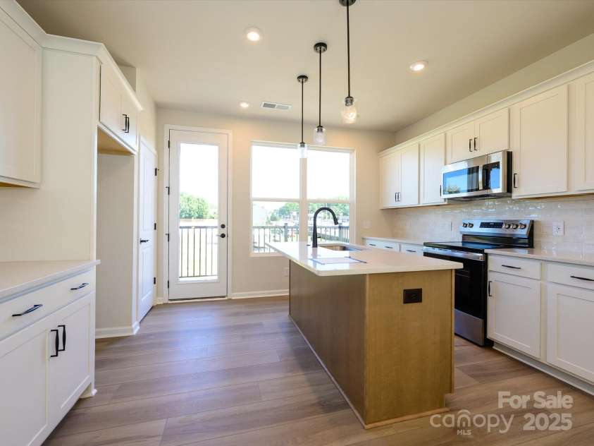 5711 Castlerea Drive, Charlotte, NC 28217.  MLS# CAR4232177, YatesRealty ID 3882. Leading to the outdoor living space, this kitchen is bathed in light.