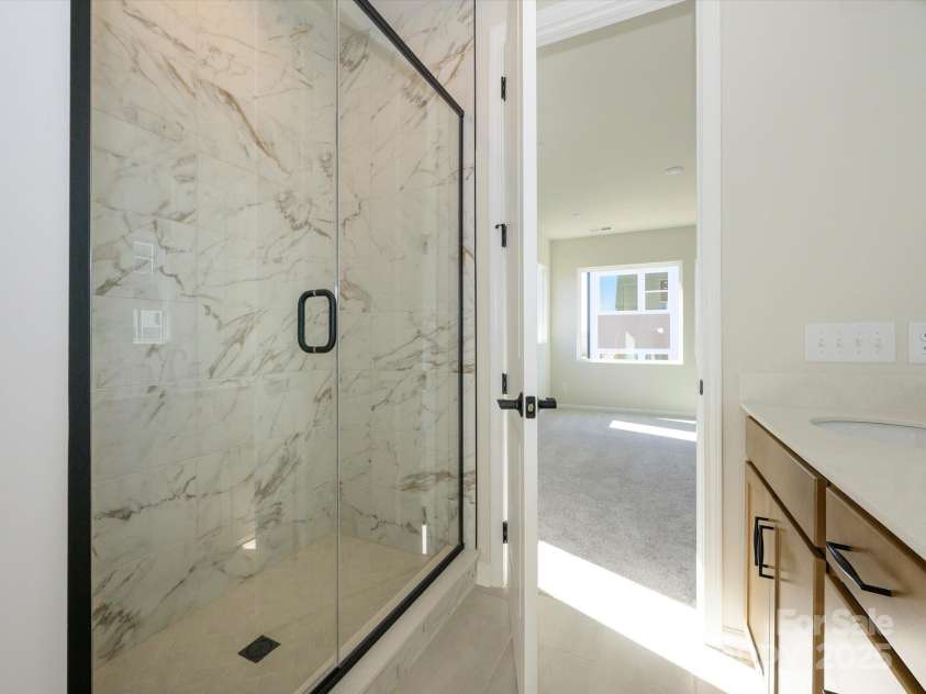 5711 Castlerea Drive, Charlotte, NC 28217.  MLS# CAR4232177, YatesRealty ID 3882. Modern tile surround walk-in shower.