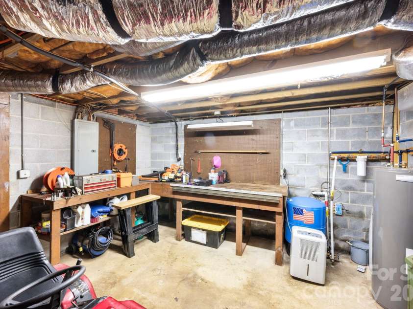 82 Sharon Road, Fairview, NC 28730.  MLS# CAR4404789, YatesRealty ID 38830. Additional Basement Workshop/Storage Area
