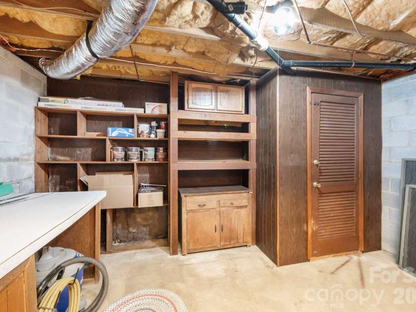 82 Sharon Road, Fairview, NC 28730.  MLS# CAR4404789, YatesRealty ID 38830. Basement Storage or Workshop Area