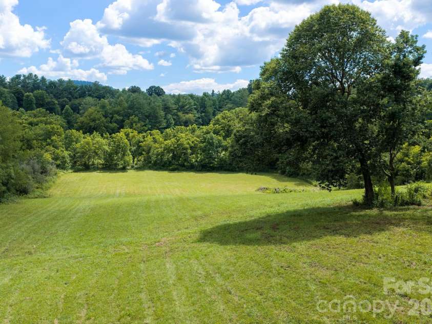 82 Sharon Road, Fairview, NC 28730.  MLS# CAR4404789, YatesRealty ID 38830. Relatively flat land boarded in the back by Cane Creek
