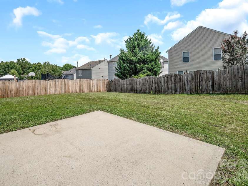 825 Chastain Avenue, Concord, NC 28025.  MLS# CAR4400015, YatesRealty ID 38853. Backyard concrete patio