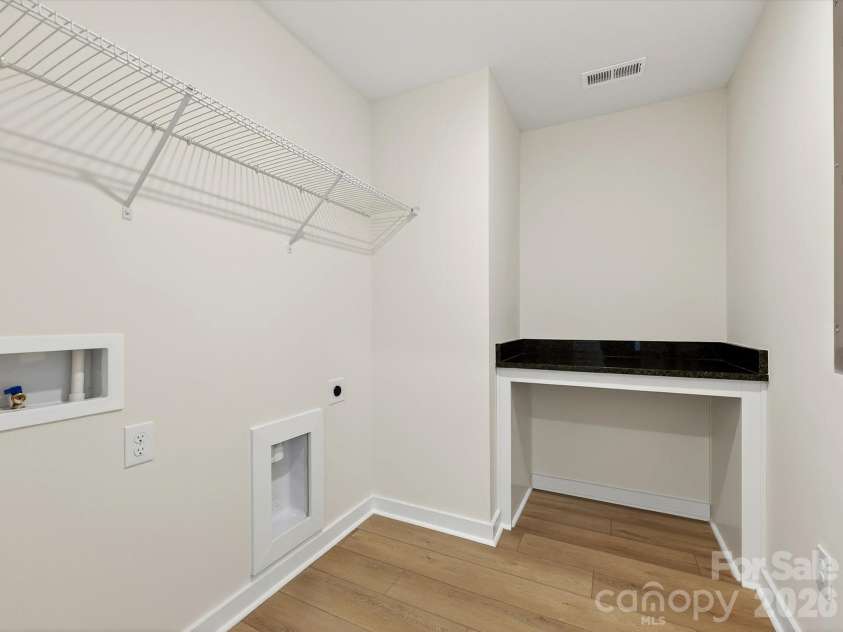 202 Quartz Hill Way, Waxhaw, NC 28173.  MLS# CAR4327858, YatesRealty ID 38881. Laundry Room has a folding table with granite countertop