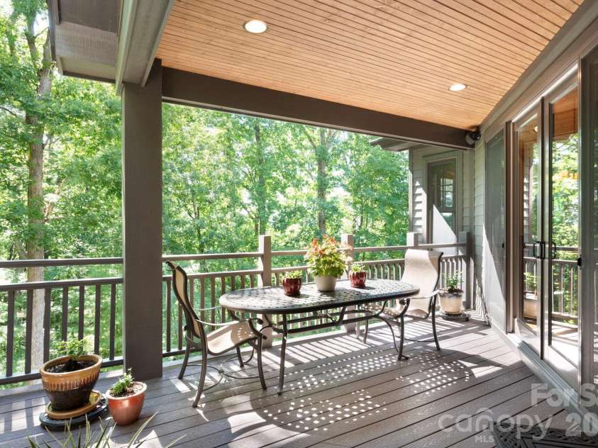 33 Hawks Branch Circle, Fairview, NC 28730.  MLS# CAR4403173, YatesRealty ID 38919. Covered deck surrounded by peaceful wooded views